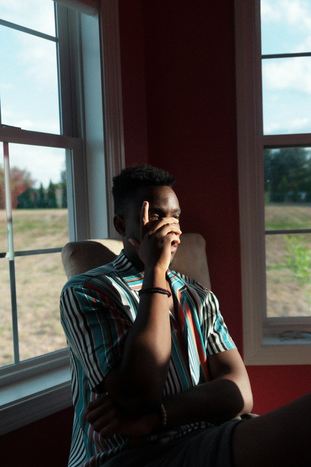 Person sitting by a window writing in a notebook